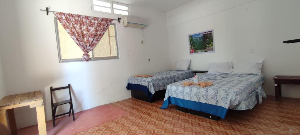 Postel nebo postele na pokoji v ubytování Villas del Carmen Hostal