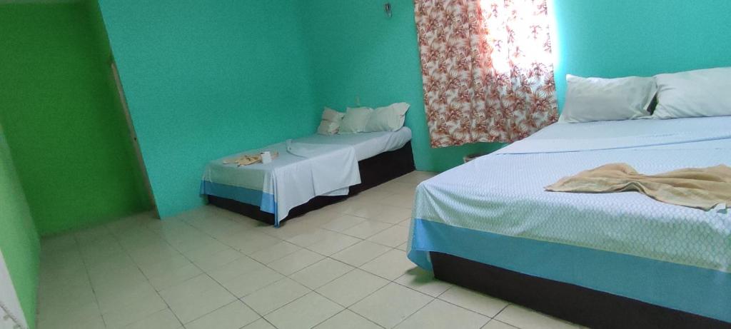 Postel nebo postele na pokoji v ubytování Villas del Carmen Hostal