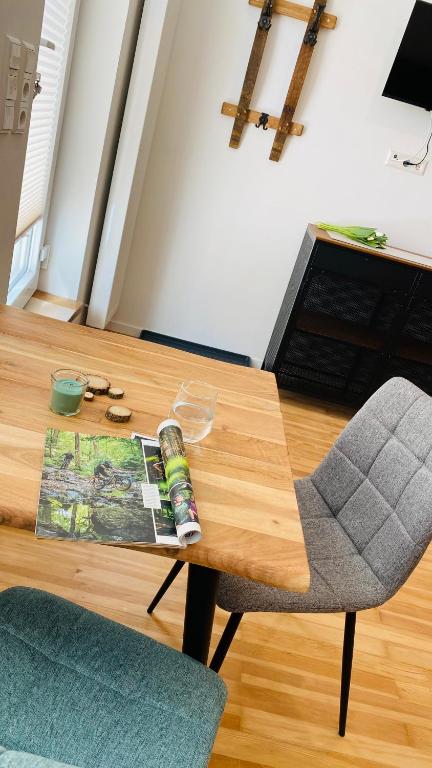 a living room with a table and a chair at Heimatliebe Erfweiler Wohnung ZWÄ in Erfweiler