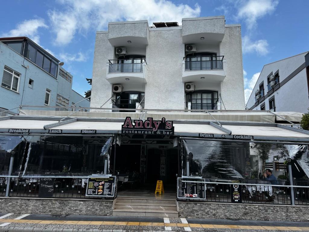 a building with an aavis restaurant in front of it at Andy's Apart Hotel in Marmaris