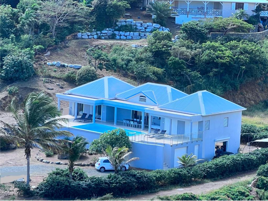 une vue aérienne sur une maison avec un toit bleu dans l'établissement Villa Taïana, à Saint-Martin