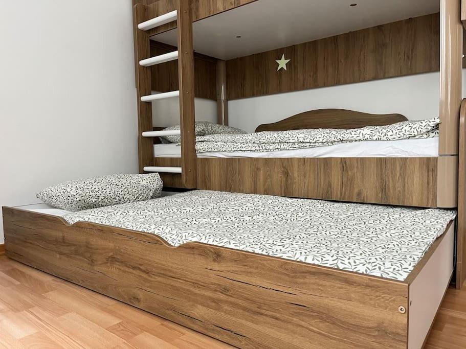 a bedroom with two bunk beds and a wooden floor at Sweet Home Vienna 1 in Vienna