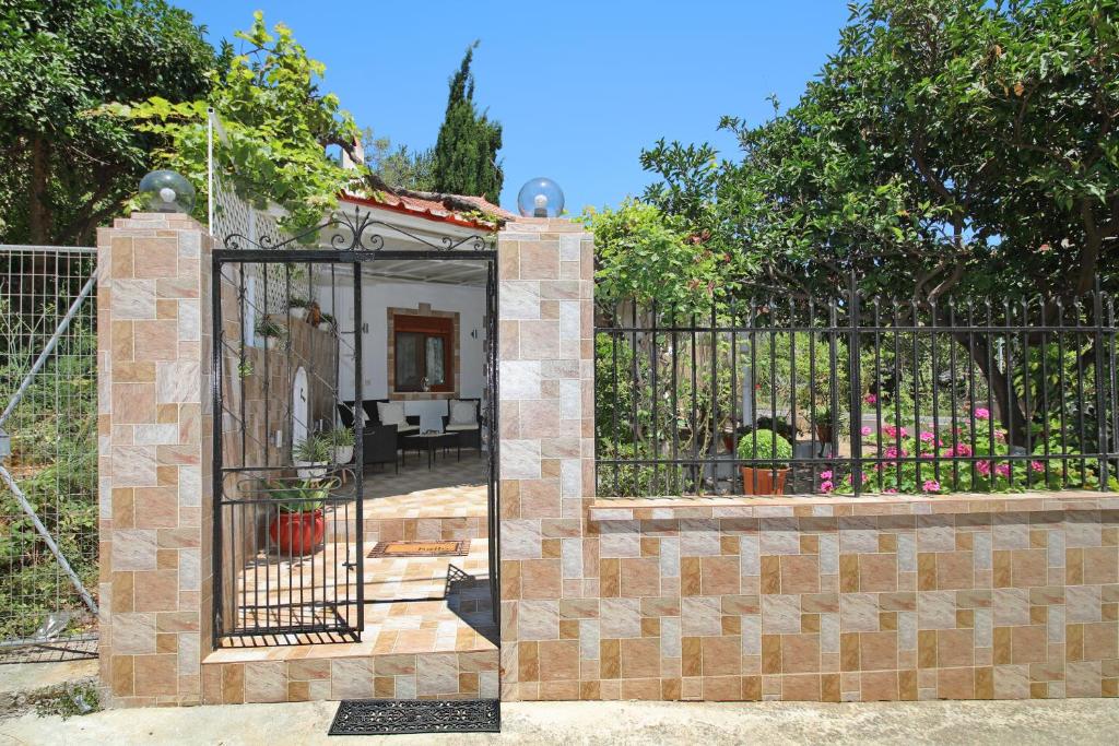 a gate to a house with a fence at Vasia's Small Villa in Skopelos Town