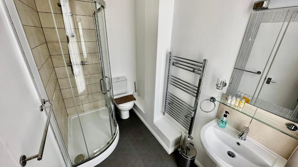 a bathroom with a shower and a sink and a toilet at Andorra Guest Accommodation in Brighton & Hove