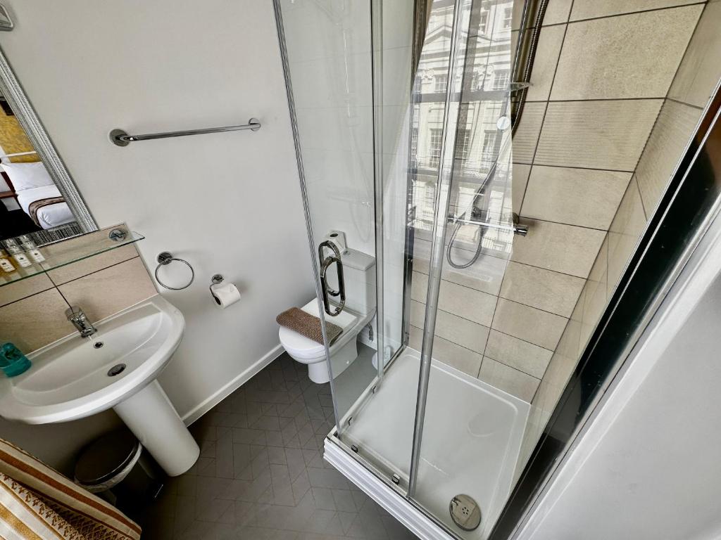 a bathroom with a shower and a sink and a toilet at Andorra Guest Accommodation in Brighton & Hove