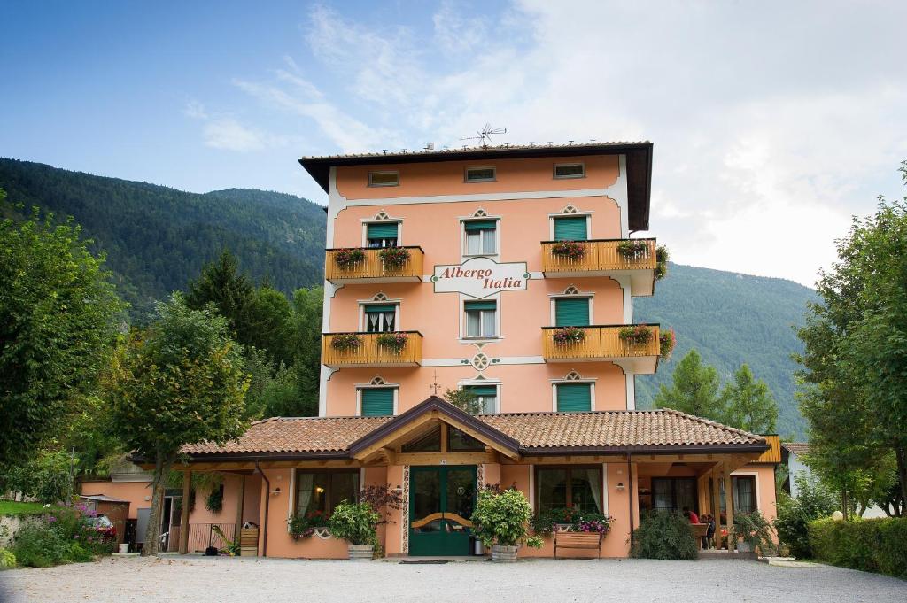 a large building with balconies on the side of it at Albergo Italia in Molveno