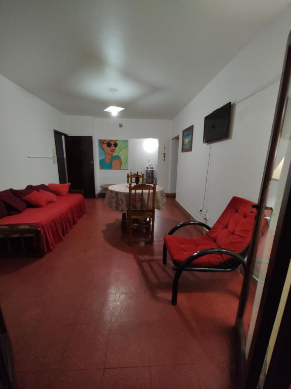 a living room with a red couch and a table at Edificio Engwald in Eldorado
