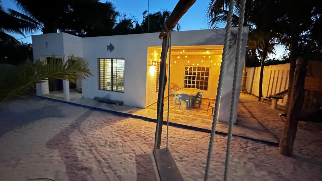 a swing in front of a house at night at Casa De Los Peces in San Crisanto