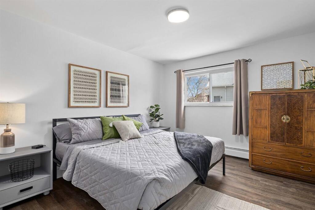 Brand New 1BR Flat, Cozy King Suite في Mount Clemens: غرفة نوم بسرير وخزانة ونافذة