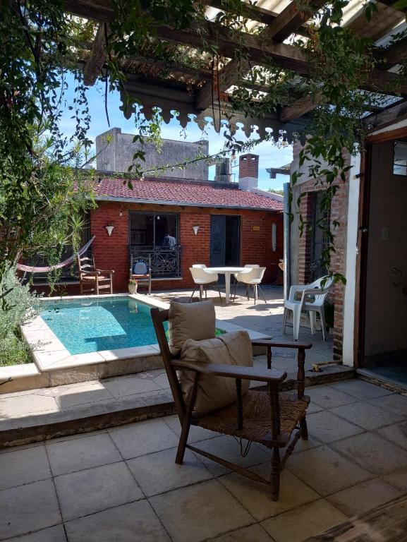 a patio with a table and chairs and a pool at Casona Veroka in San Pedro