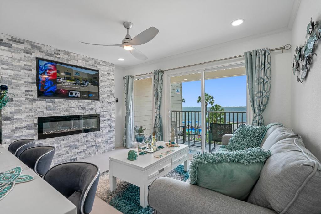 a living room with a couch and a fireplace at Welcome to Sea Forever - Balcony Water View Tampa in Tampa