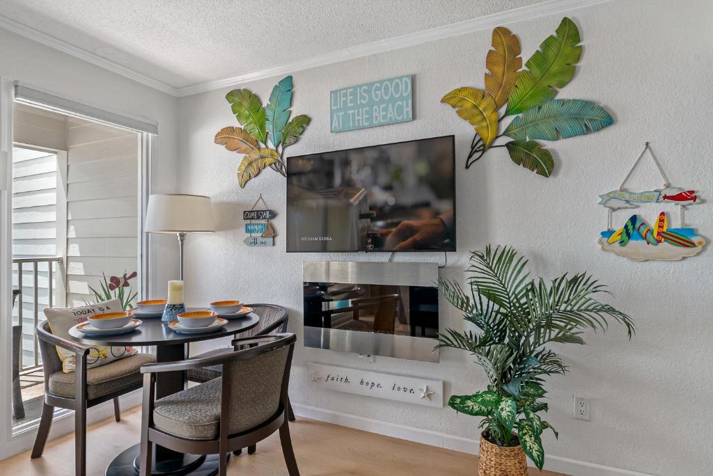 a dining room with a table with chairs and a fireplace at Paradise Beach Sailport Resort Condo in Tampa