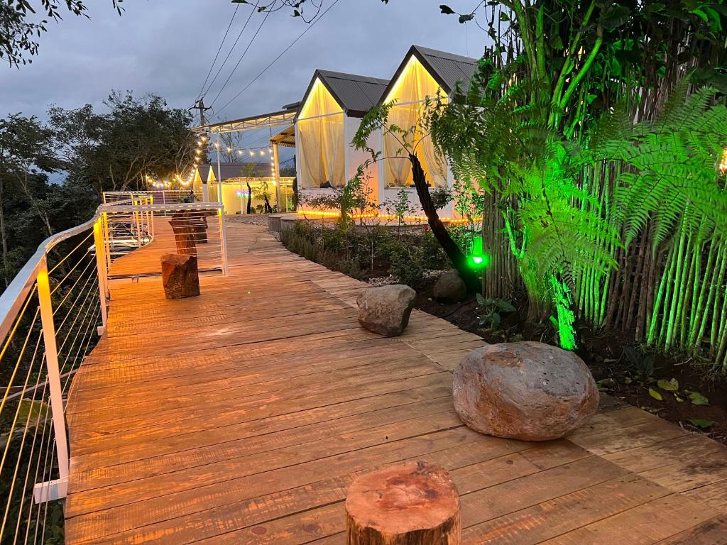 a wooden walkway with trees and rocks on it at Retro Khe Sanh in Lao Bao