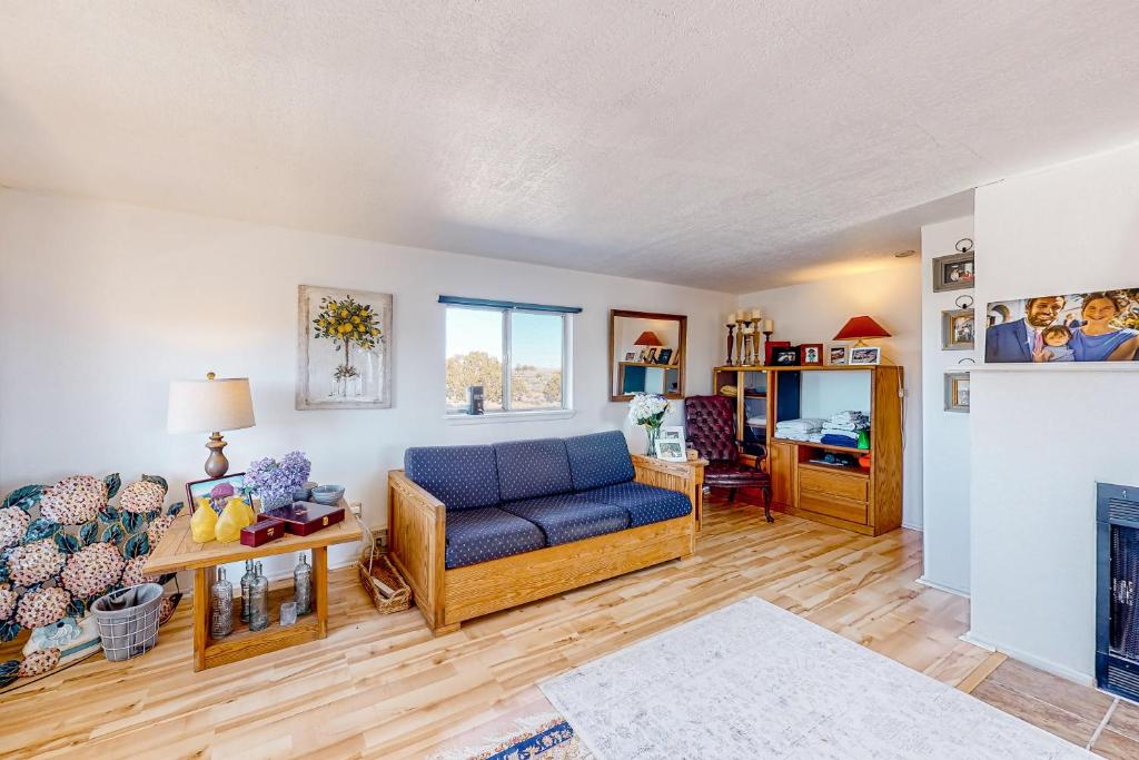 a living room with a blue couch and a fireplace at Mountain Vista - Barn in Hesperus