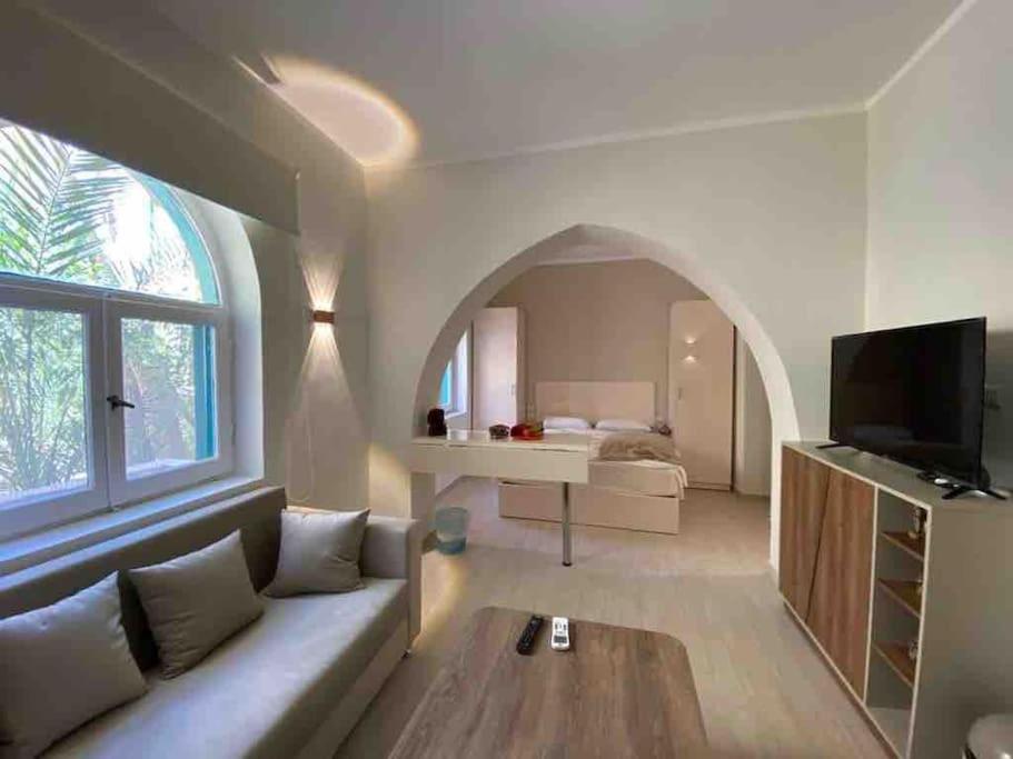 a living room with a couch and an arched window at Stay in the center of Elgouna in Hurghada