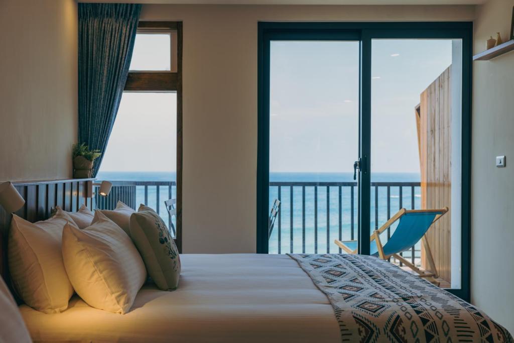 Postel nebo postele na pokoji v ubytování Chuanfanrock Haku Beach Days Inn