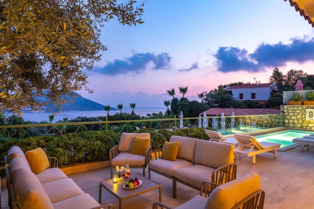 a patio with couches and chairs and a pool at Spacious 5 Bedroom Villa with Private Pool in Kas