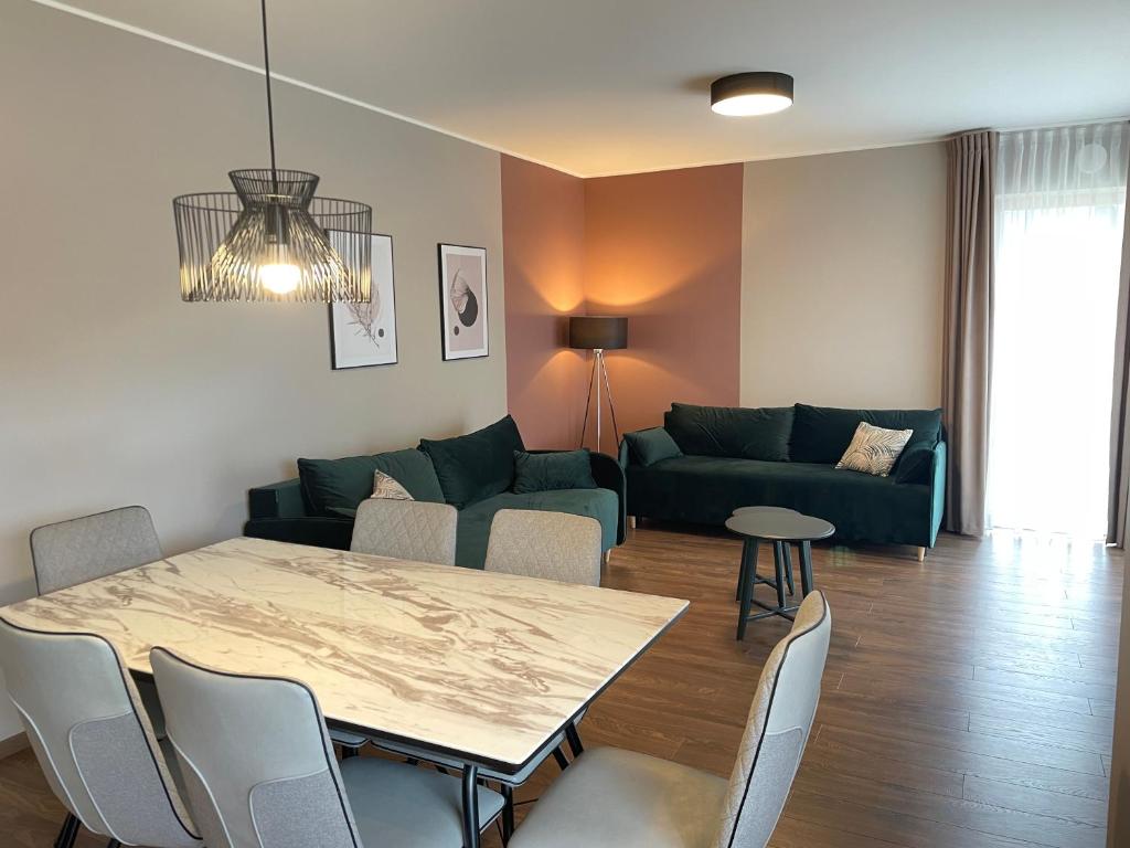 a living room with a table and a couch at Tulbi Apartment in Pärnu