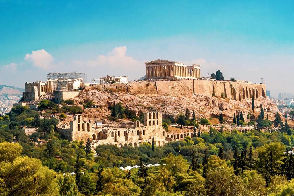 a view of the acropolis of athens from atop a mountain at Экскурсии в Афинах Гид Афины in Athens