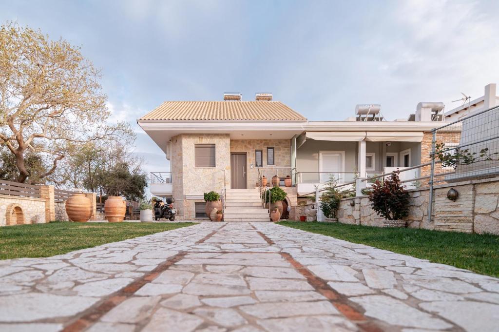 a house with a stone driveway in front of it at Villa Athina in Preveza
