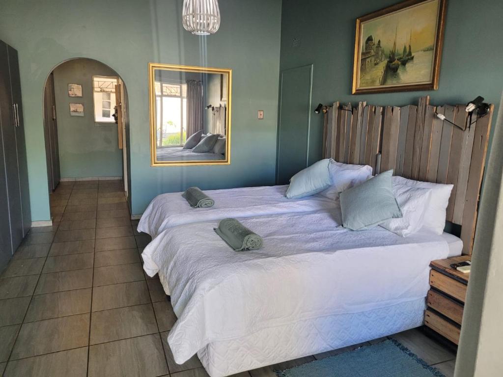 a bedroom with a large bed with two pillows on it at 29B Zebra Street - InHimwe Guesthouse in Polokwane