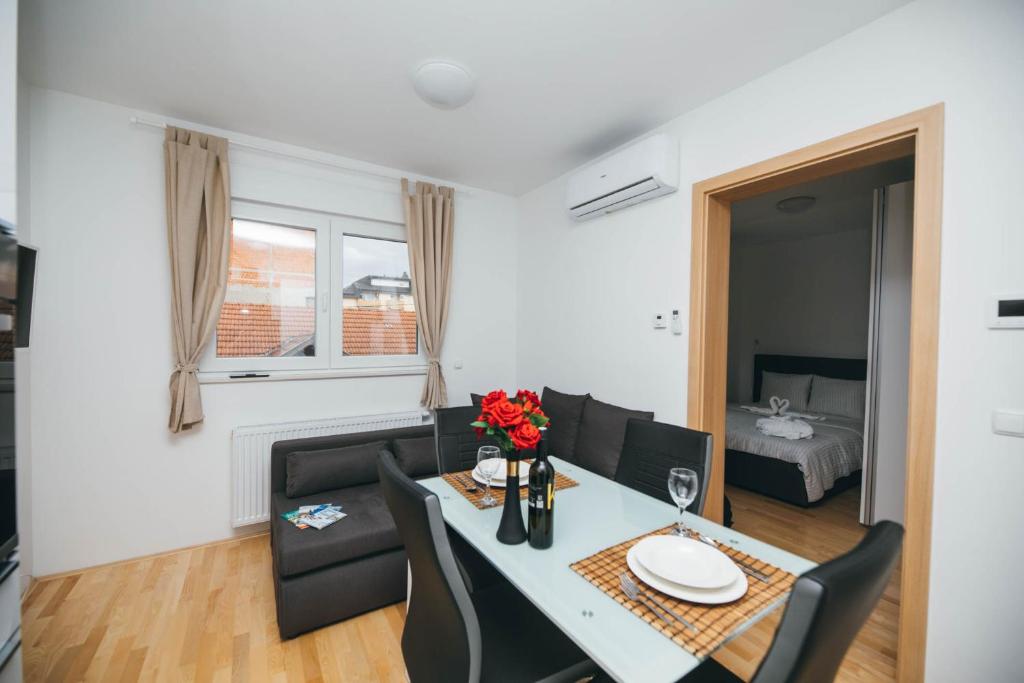 a living room with a dining room table and chairs at New & Modern smart HOME, FREE parking in Zagreb