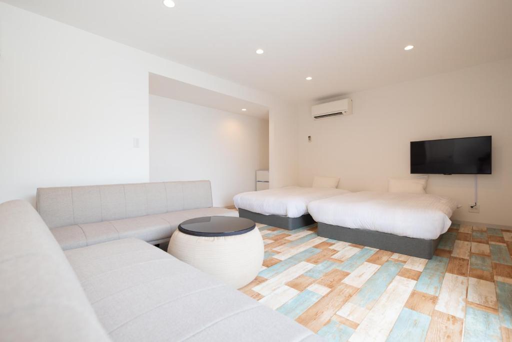 a living room with two beds and a couch at BLUE MOON in Kawazu