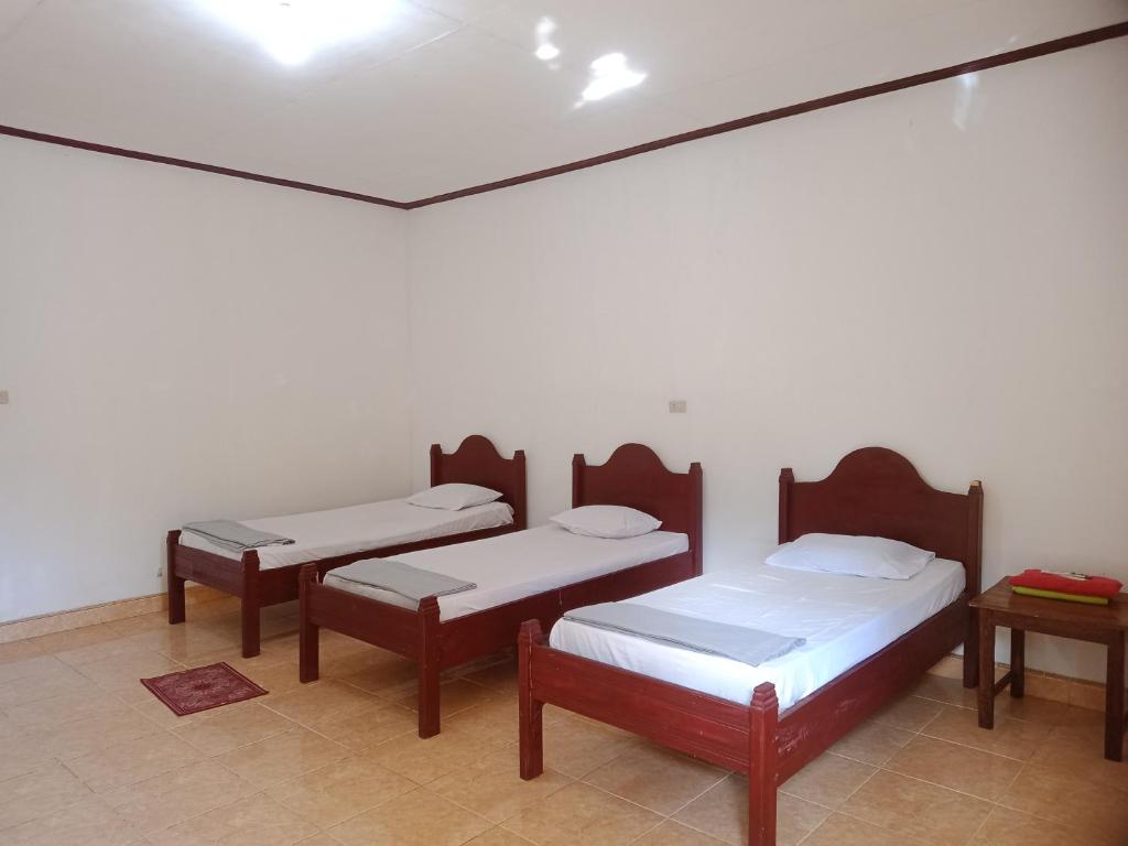 Postel nebo postele na pokoji v ubytování Harus Damai Inn