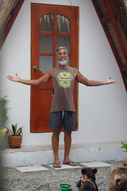 a man standing in front of a door at Hiraya Baler Beachfront Cabanas in Baler