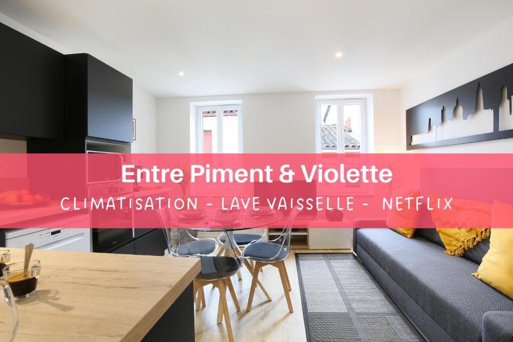 a living room with a couch and a table at expat renting - Entre Piment & Violette - Saint Michel in Toulouse