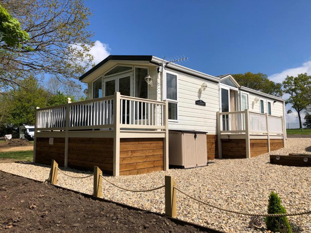 a mobile home with a porch and a deck at Whitwell and Reepham Station - GEORGIE in Reepham