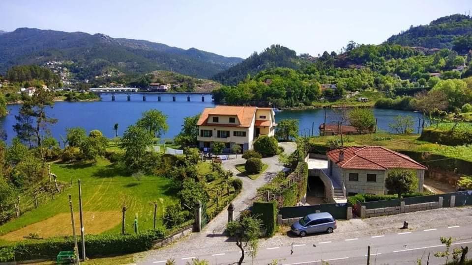 a house on the side of a lake at Casa Cosme in Braga