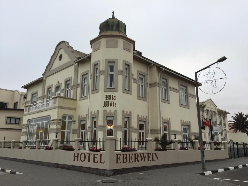 a hotel building with a clock on top of it at Hotel Eberwein in Swakopmund