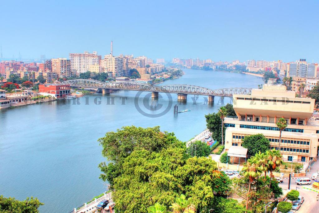 a view of a river with a bridge in a city at Nile Riviera in Mansoura in Mansoura