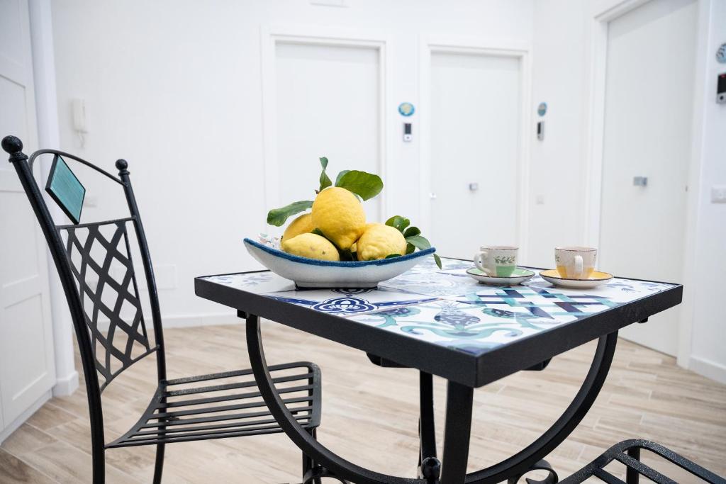 a bowl of fruit on a table with a chair at B&B DieMme Amalfi Coast in Vietri sul Mare