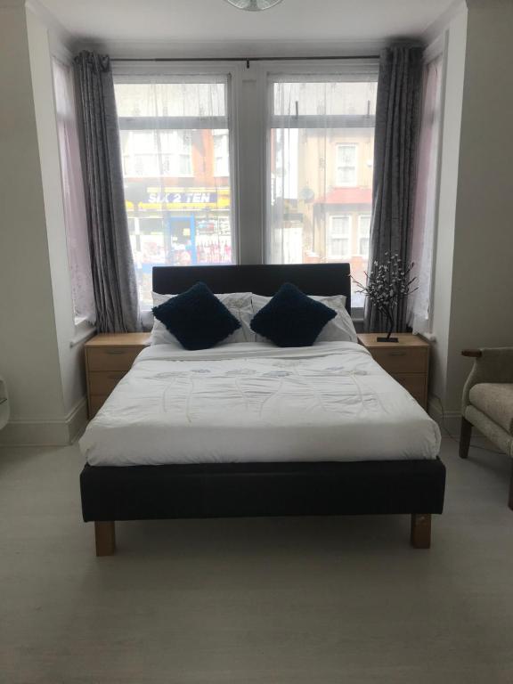 a bed with two pillows in a bedroom with windows at Dream Nest in Southend-on-Sea