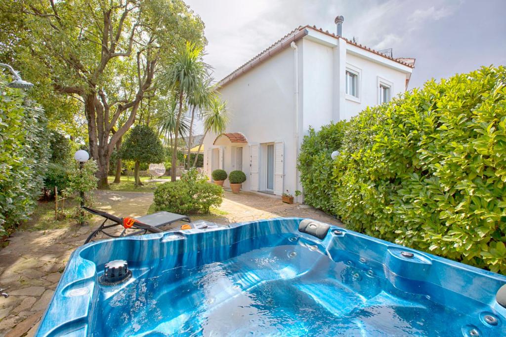 a blue tub in front of a house at AMORE RENTALS - Resort Ravenna - Villa Dama in Massa Lubrense