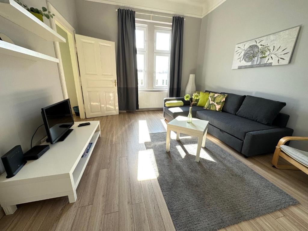 a living room with a couch and a table at ORANGEHOMES One Bedroom Cozy Apartment in Budapest