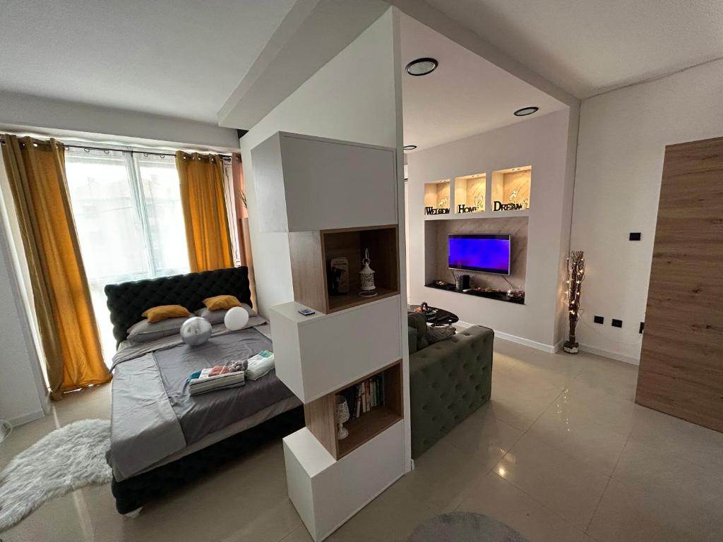 a living room with a bed and a couch at Family Apartment in Niš