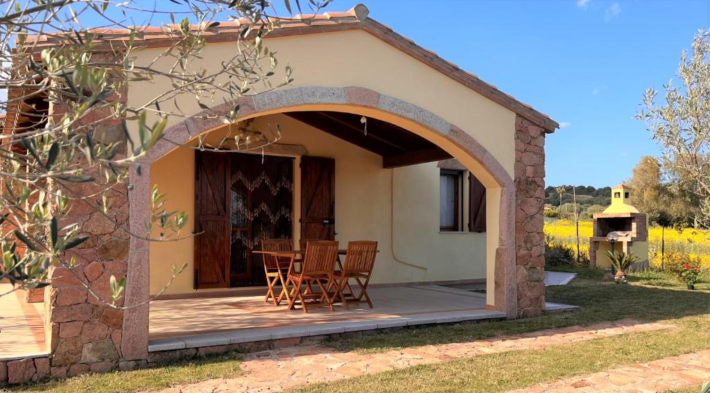 a patio with chairs and a table in front of a house at Villa Patrizia in Castiadas