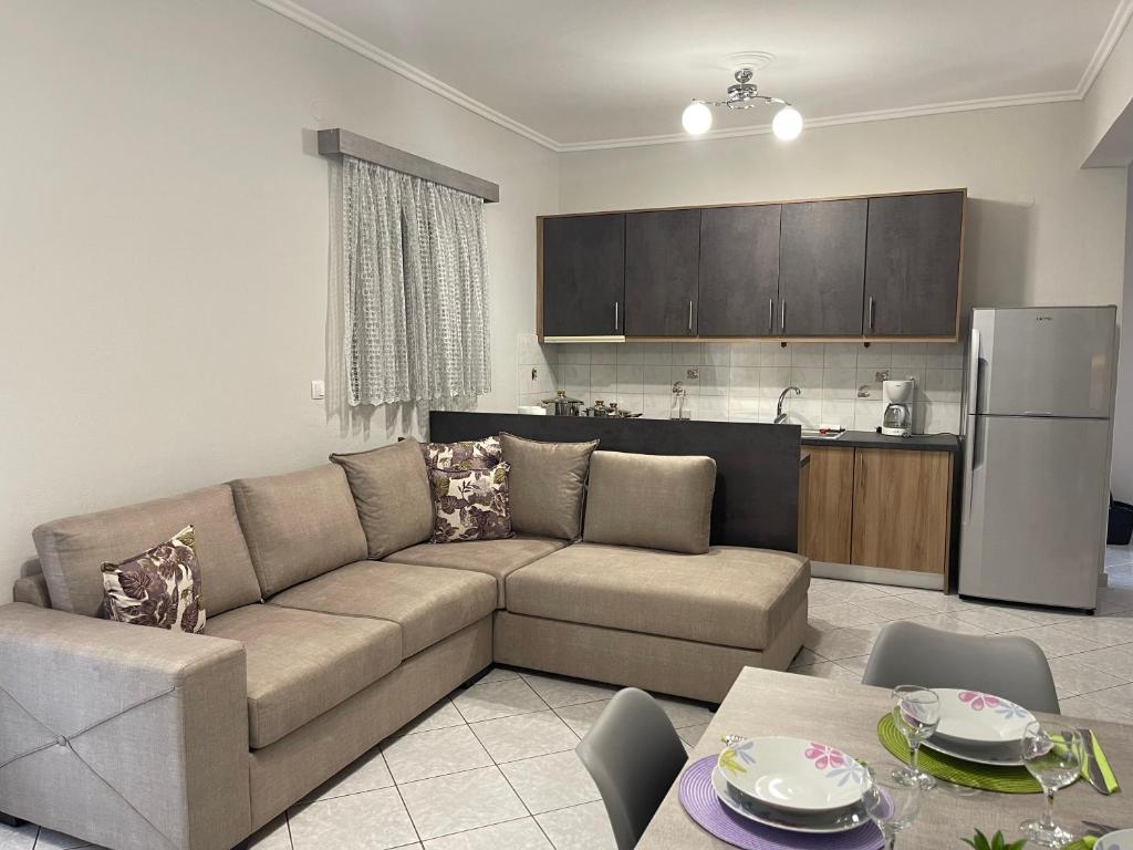 a living room with a couch and a kitchen at Litsa's Apartment in Igoumenitsa