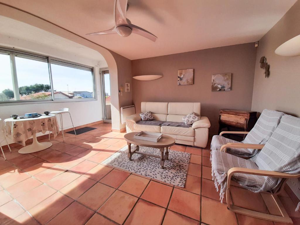 - un salon avec un canapé et une table dans l'établissement Superbe T4, vue mer, Narbonne Plage, à Narbonne-Plage