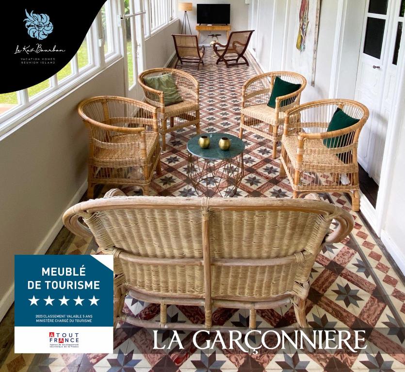 a lobby with wicker chairs and a table at La Garçonniere in Saint-Pierre