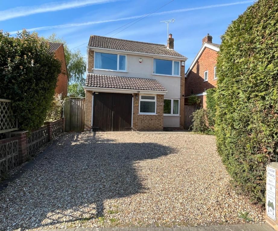 a house with a driveway in front of it at Cedar Place in Southwell in Southwell