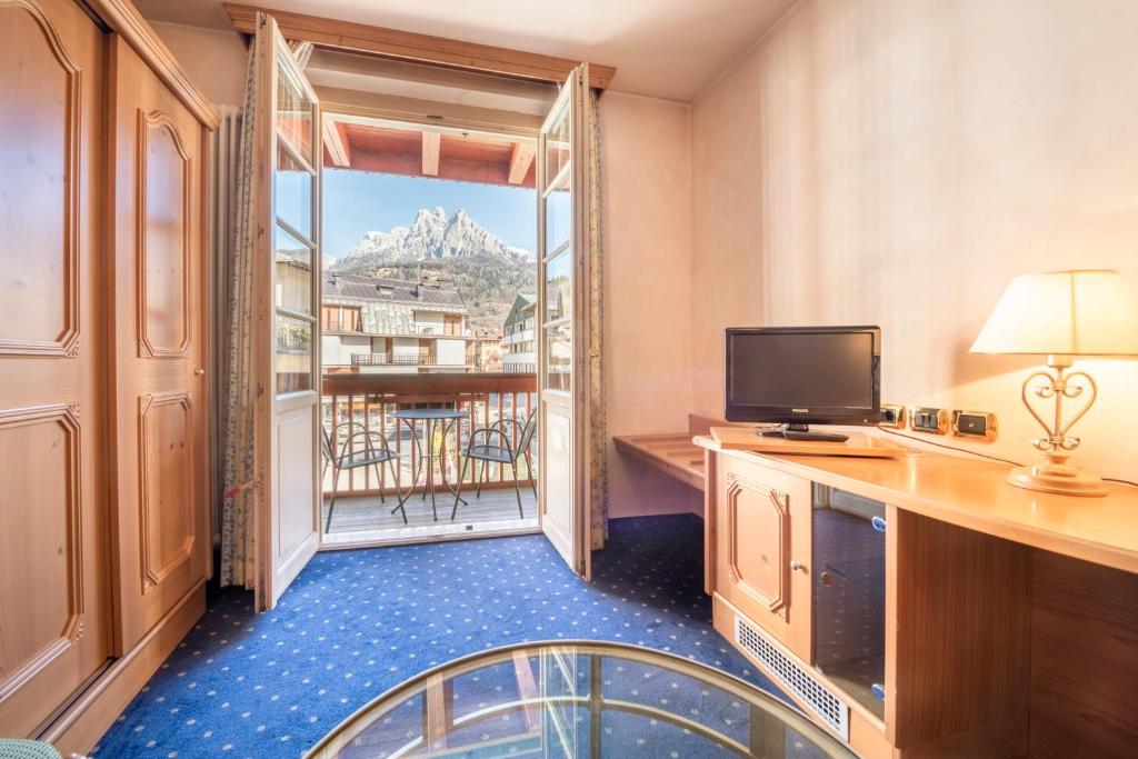 TV a/nebo společenská místnost v ubytování Hotel Relais Orsingher