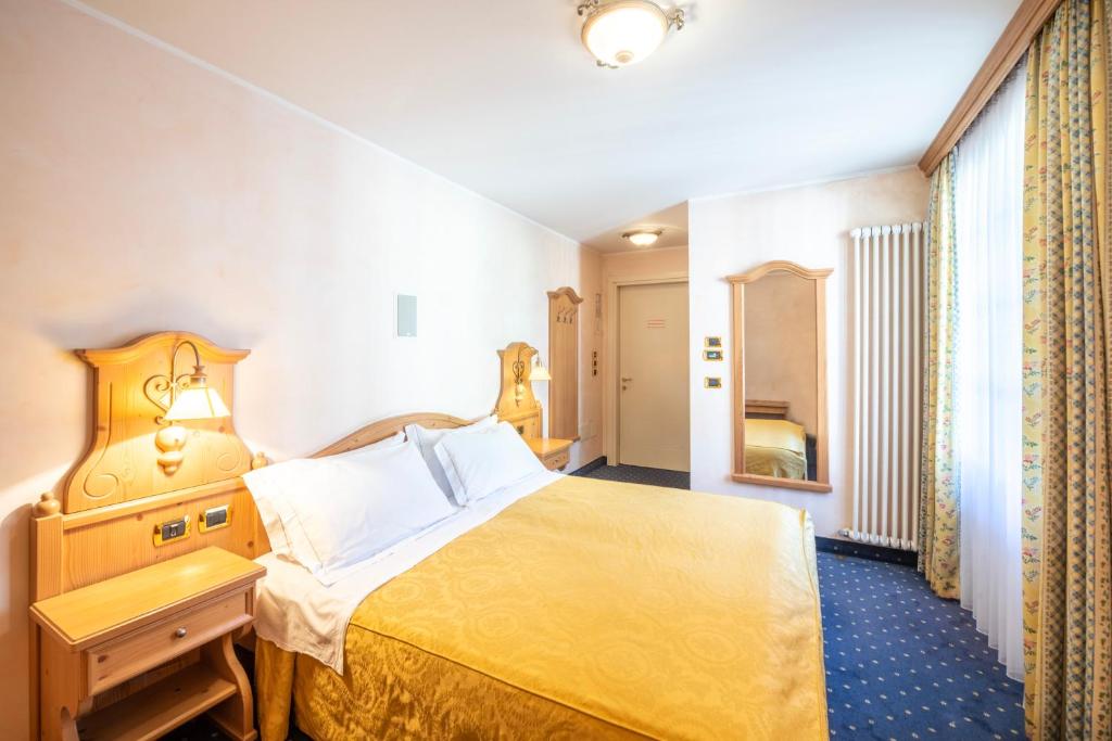 Postel nebo postele na pokoji v ubytování Hotel Relais Orsingher