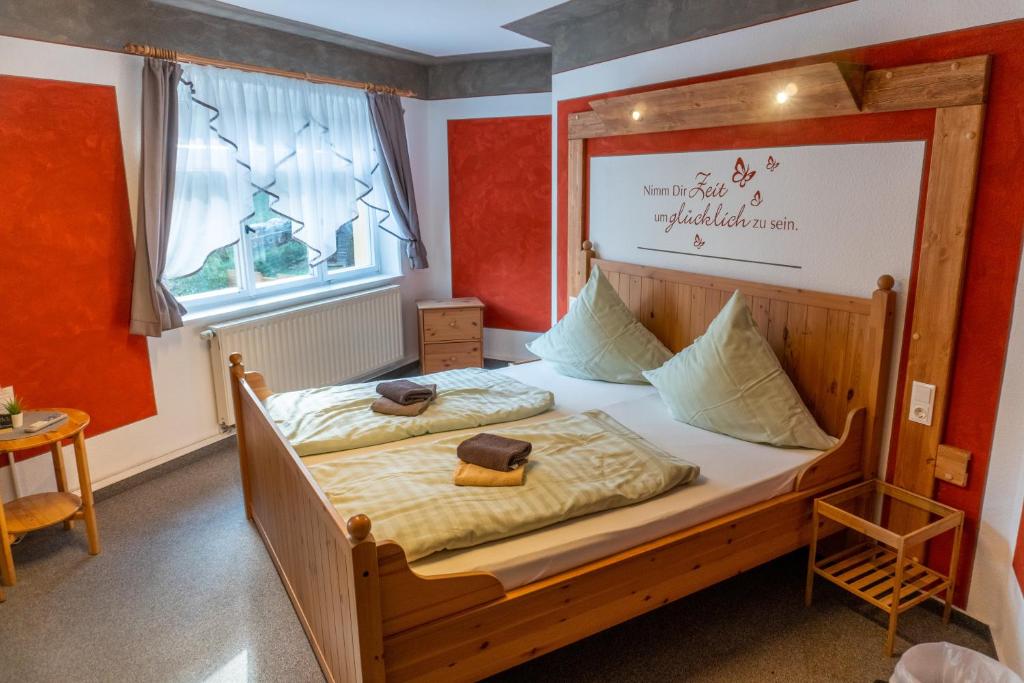 a bedroom with a bed with a sign on it at Pension Schrammsteinbaude in Bad Schandau