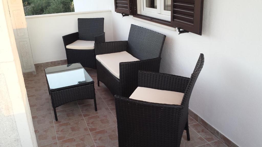 a row of chairs and a table on a balcony at Apartment Sevid in Sevid