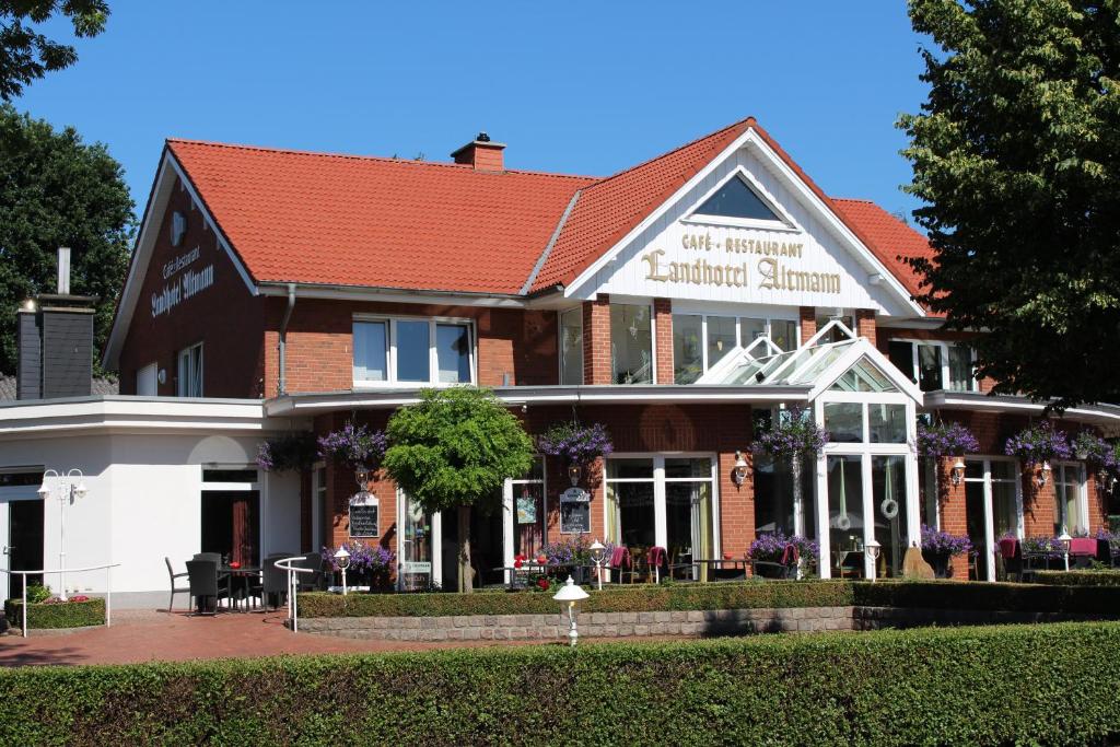 a large building with a red roof at Landhotel Altmann in Hörstel