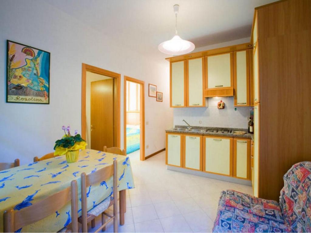 a kitchen and a dining room with a table and chairs at Homely apartment close to the beach - Beahost in Rosolina Mare